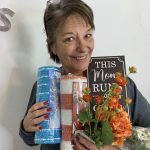 stephanie holding mesh and a sign